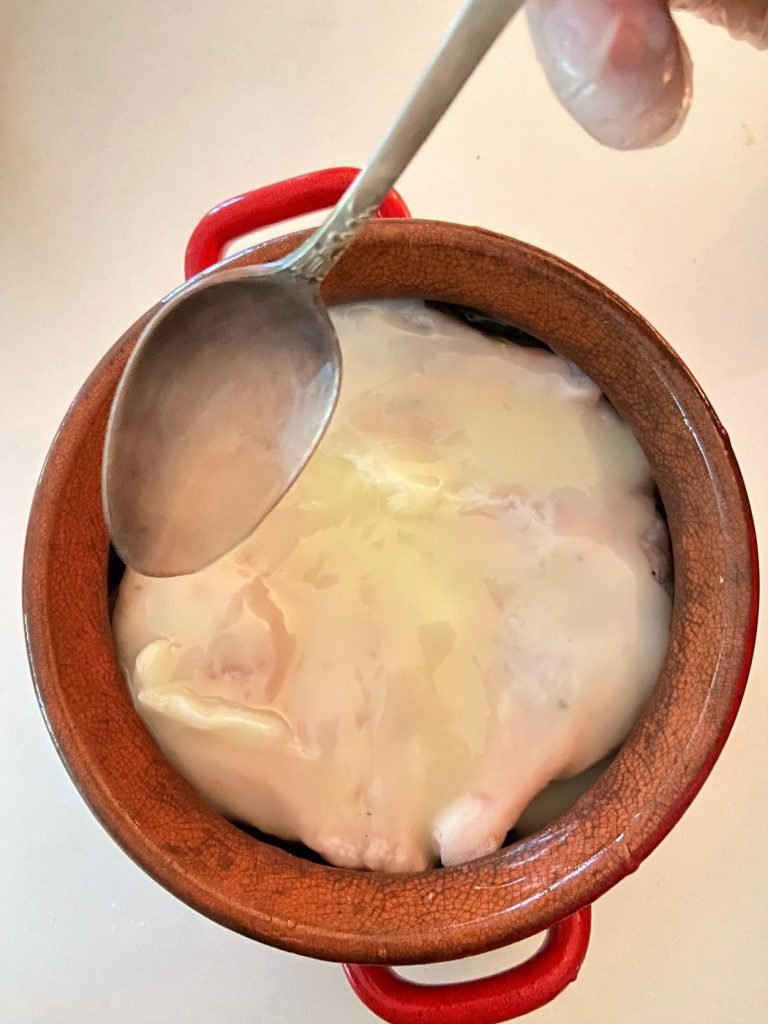 duck legs in an oven-proof dish submerged in fat