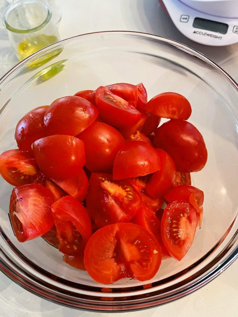 quarter Campari tomatoes before crushing them in a blender