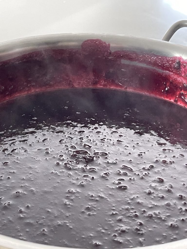 cooked blackcurrant jam ready go into canning jars